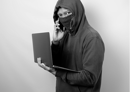 Masked person with laptop